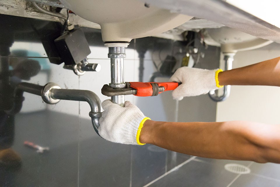 Plumber repairing a damaged drain line
